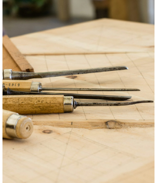the tools used for wood engraving shown up close in situ in the wood carver's studio
