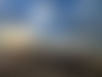Sunrise at the beach, cloudy sky and a lifeguard tower casting a shadow.
