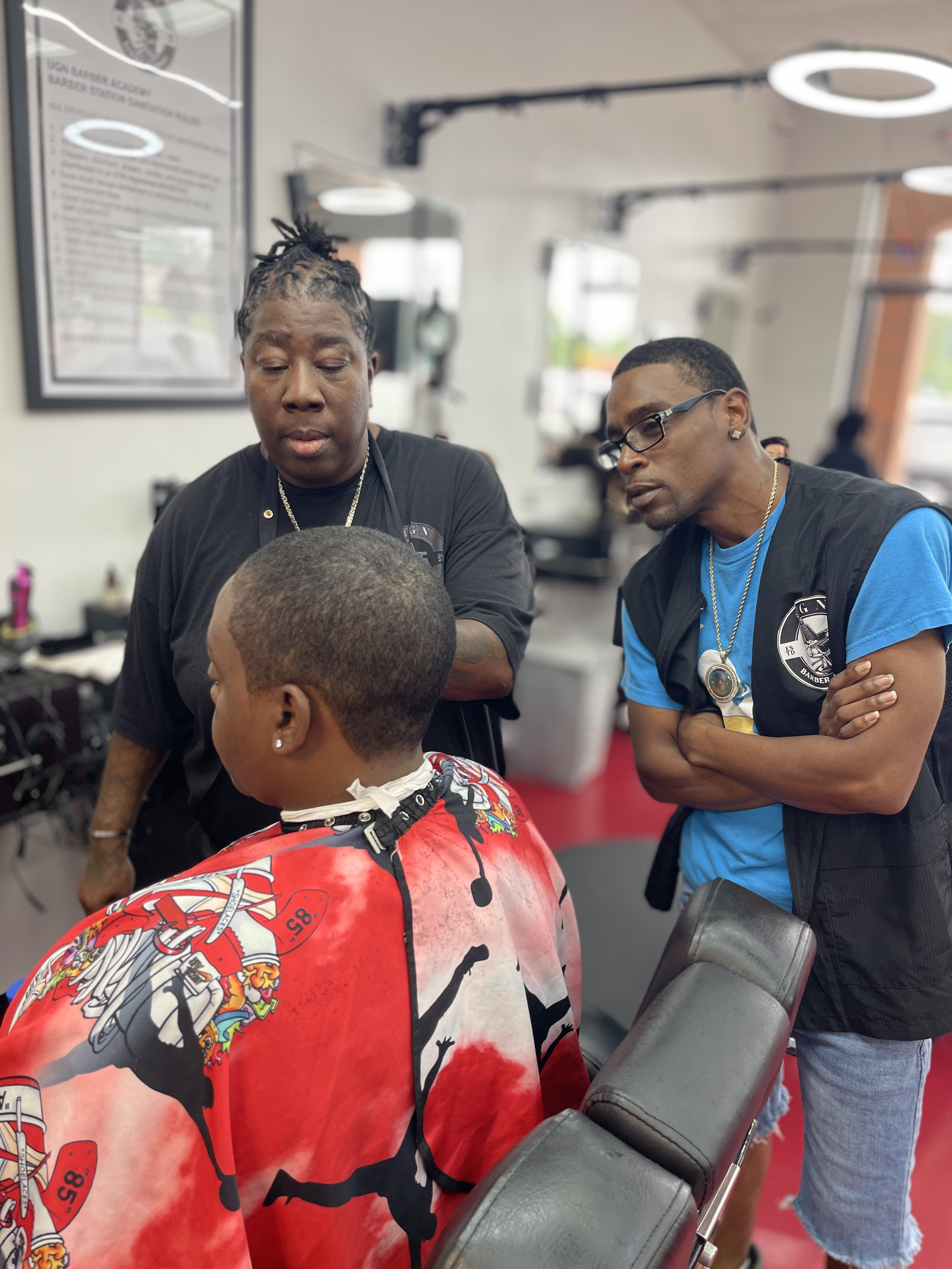 UGN Barber Academy students receiving barber training from and instructor.