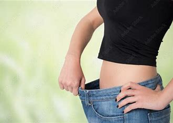 woman with loose jeans after losing weight using medical weight loss treatment