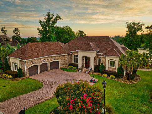 Aerial drone photograph at sunrise of a luxury home on Lake Murray in South Carolina.
