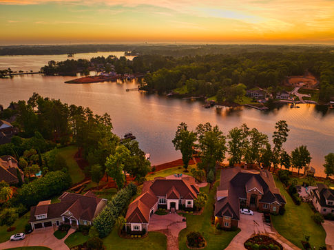Aerial drone photograph at sunrise of a luxury home on Lake Murray in South Carolina.