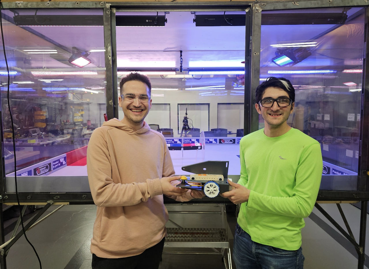 Robotics Team hold a combat robot they designed
