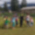 A group of children playing outside with their teacher