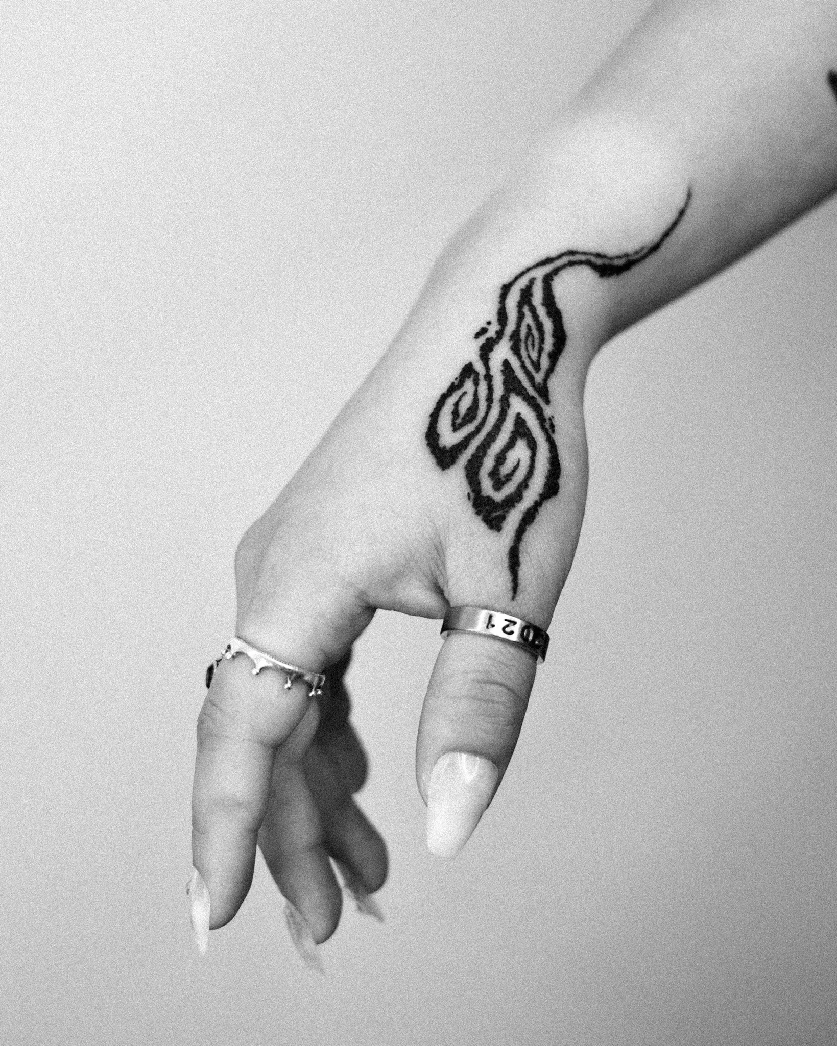 Blackwork Korean cloud flow tattoo on the back of the hand, with bold swirling organic shapes extending to the wrist. By Vequja at Seoul Ink Tattoo, Gangnam, Seoul, South Korea.