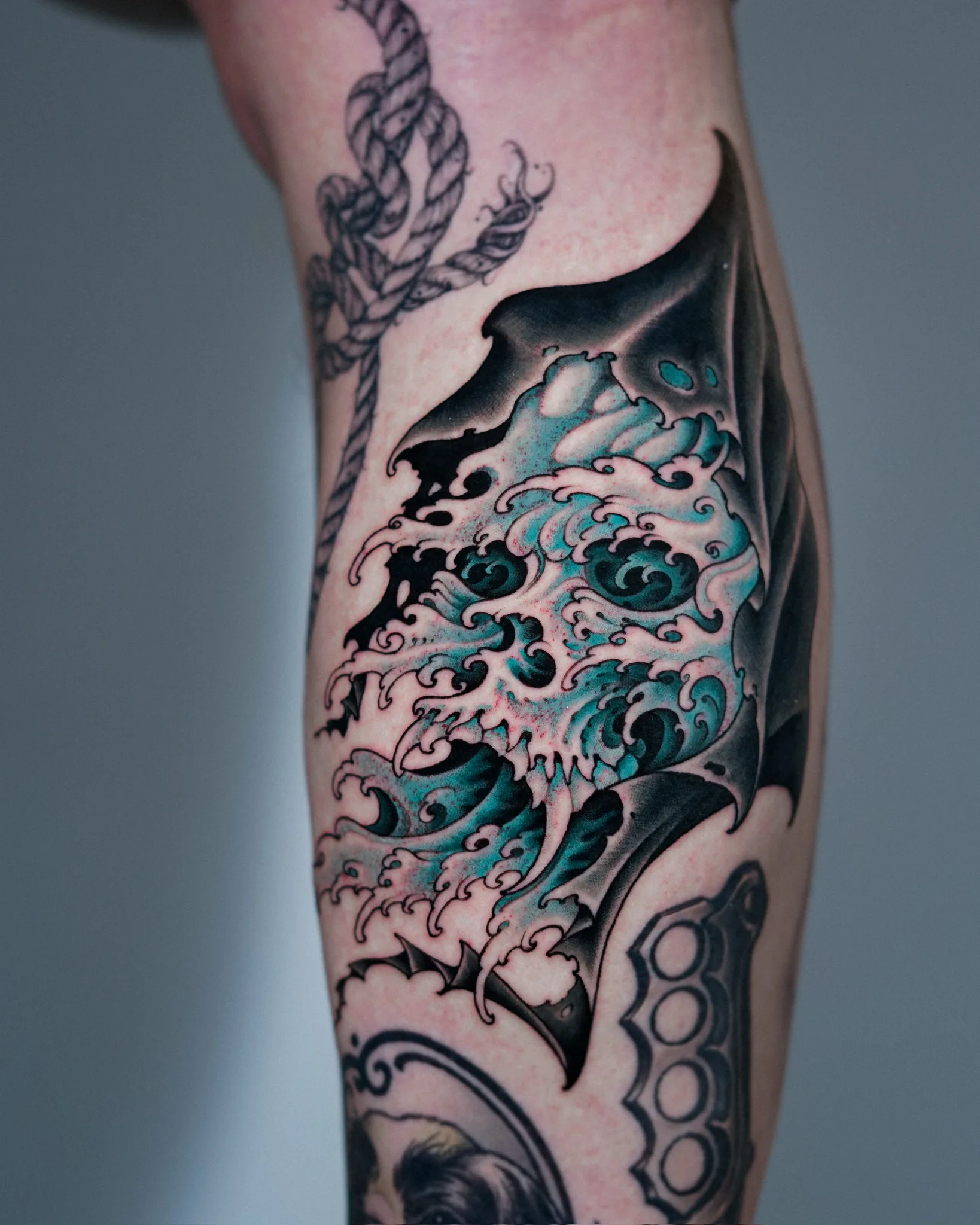 Tattoo design stencil artwork showing a Neo Japanese skull emerging from crashing waves with a coiled serpent, rendered in black ink on paper. By Jinq at Seoul Ink Tattoo, Gangnam, Seoul, South Korea.