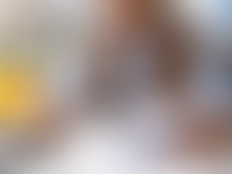 Contractor reviewing financial documents and project plans at an office desk with a calculator and laptop, illustrating how financial stability impacts contractor surety bond rates and business growth.