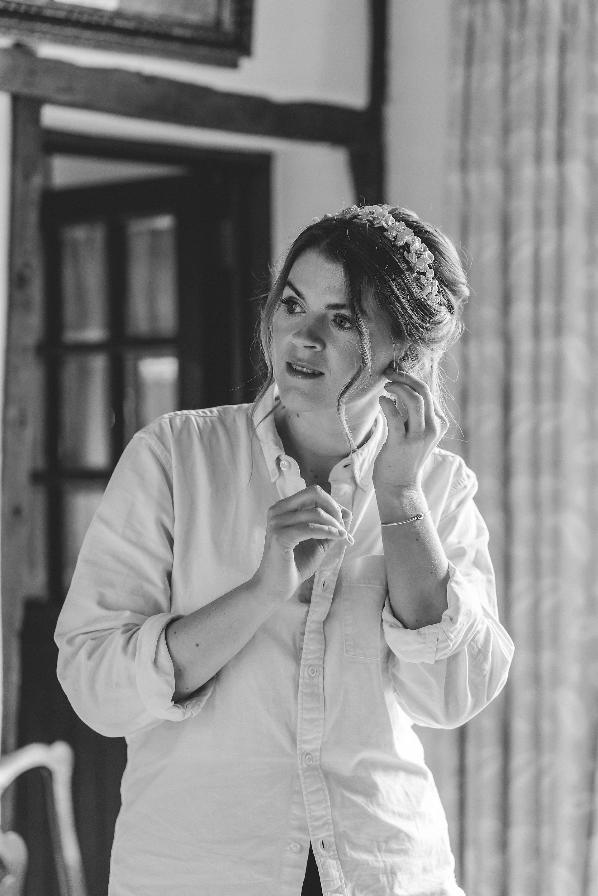 Bride putting in earrings