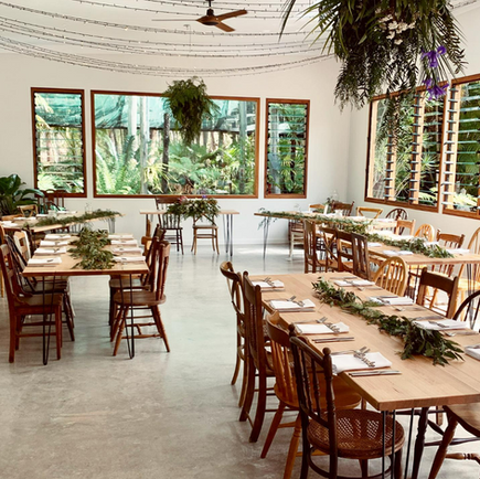 Oak dining tables with assorted vintage timber dining chairs at The Fernery Dunboggan.png