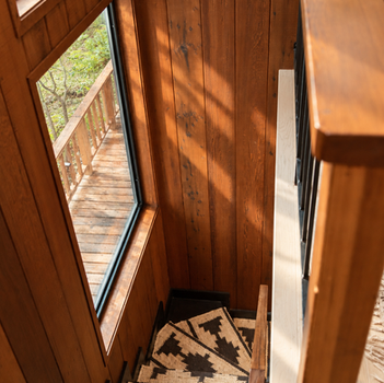 Redwood stairwell with window and patterned stair runner
