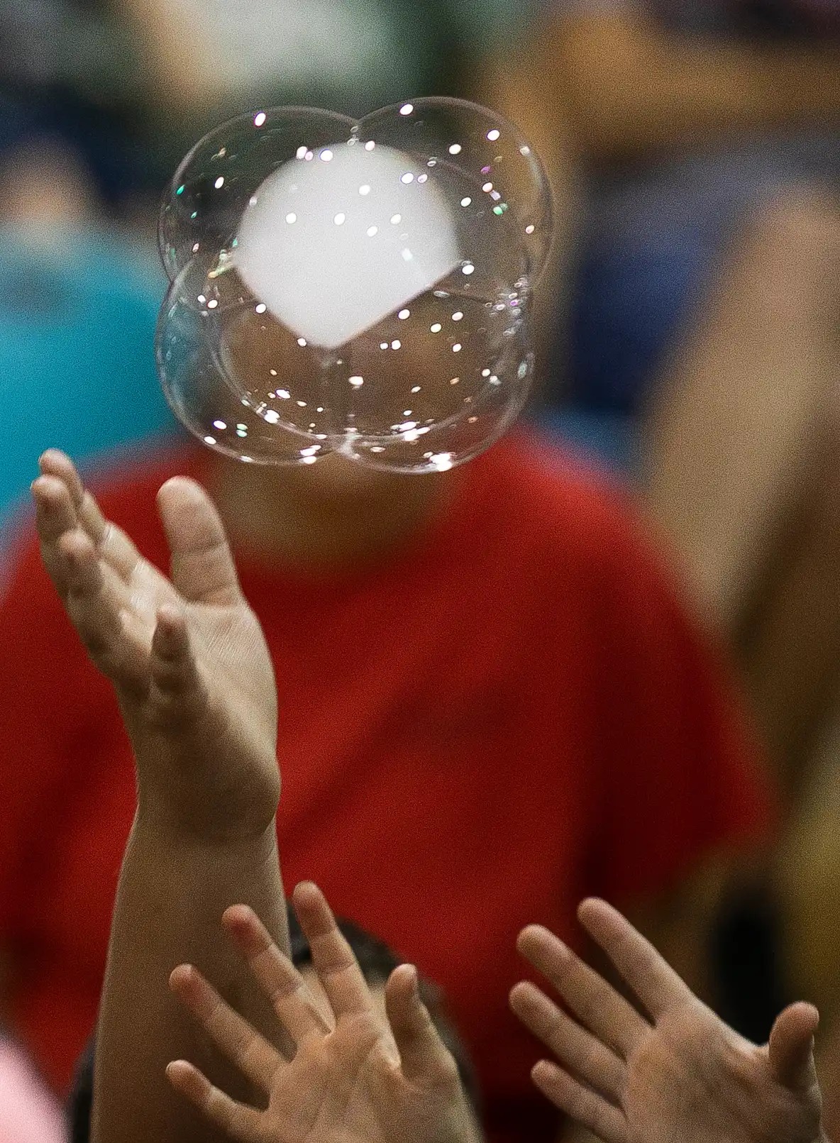 KidsReachingForBubbleSculpture.webp