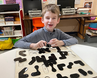 Photo of a child using PRIOR looking happy.