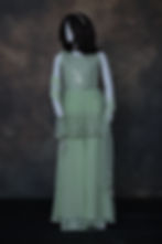 Girls' three-piece light mint green palazzo suit with a heavily sequined peplum style top, thread embroidery, and net dupatta