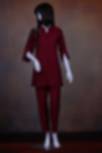 Short thigh-length top with stand collar and beaded shoulder motif