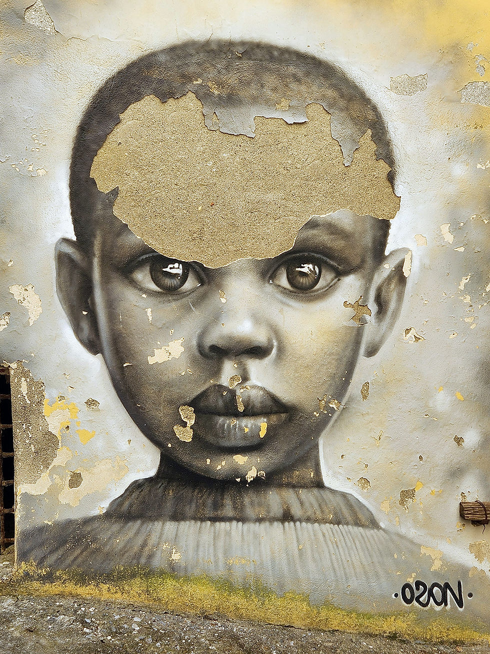 damaged mural in Diamante of little black boy