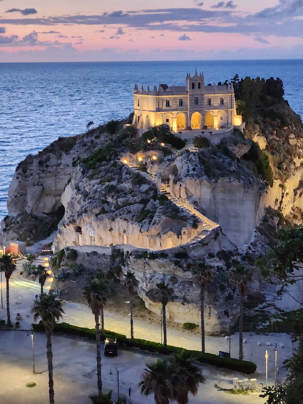 The Santa Maria dell'Isola sanctuary all lit up at sunset.
