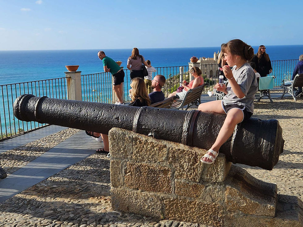 Tourists loving the cannon in the Piazza del Cannone.