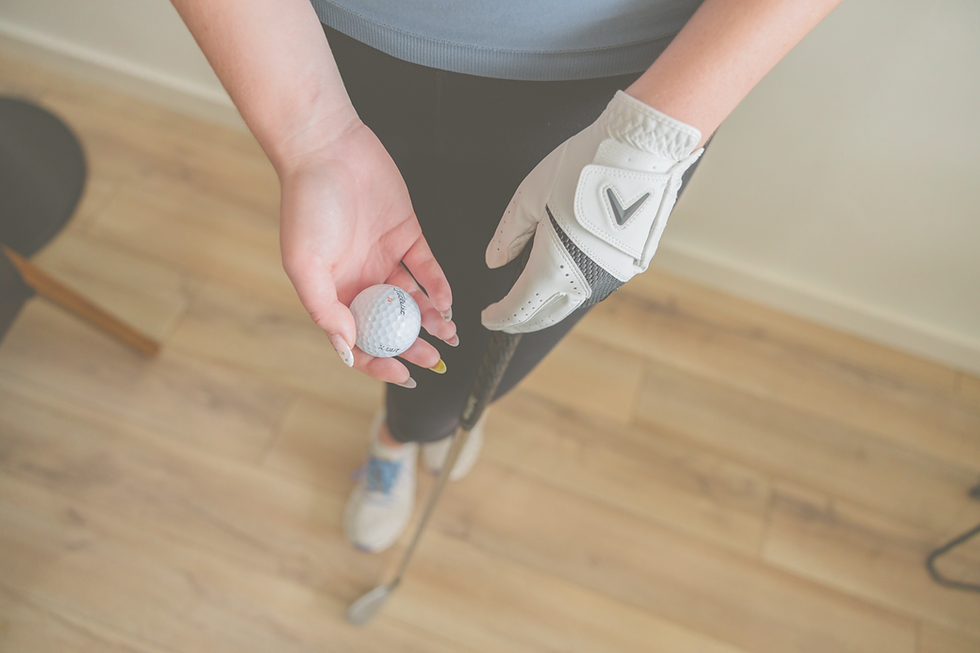 Female holding Golf Club and Ball_edited