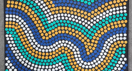 Indigenous dot painting using blue, green, yellow and white curved lines.