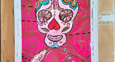 Stylized skull with floral elements stitched on to pink background, with white border.