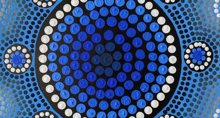 Indigenous dot painting using blue and white circles in a star shape.