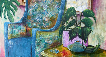 Room with a blue chair and a coffee table and plants.