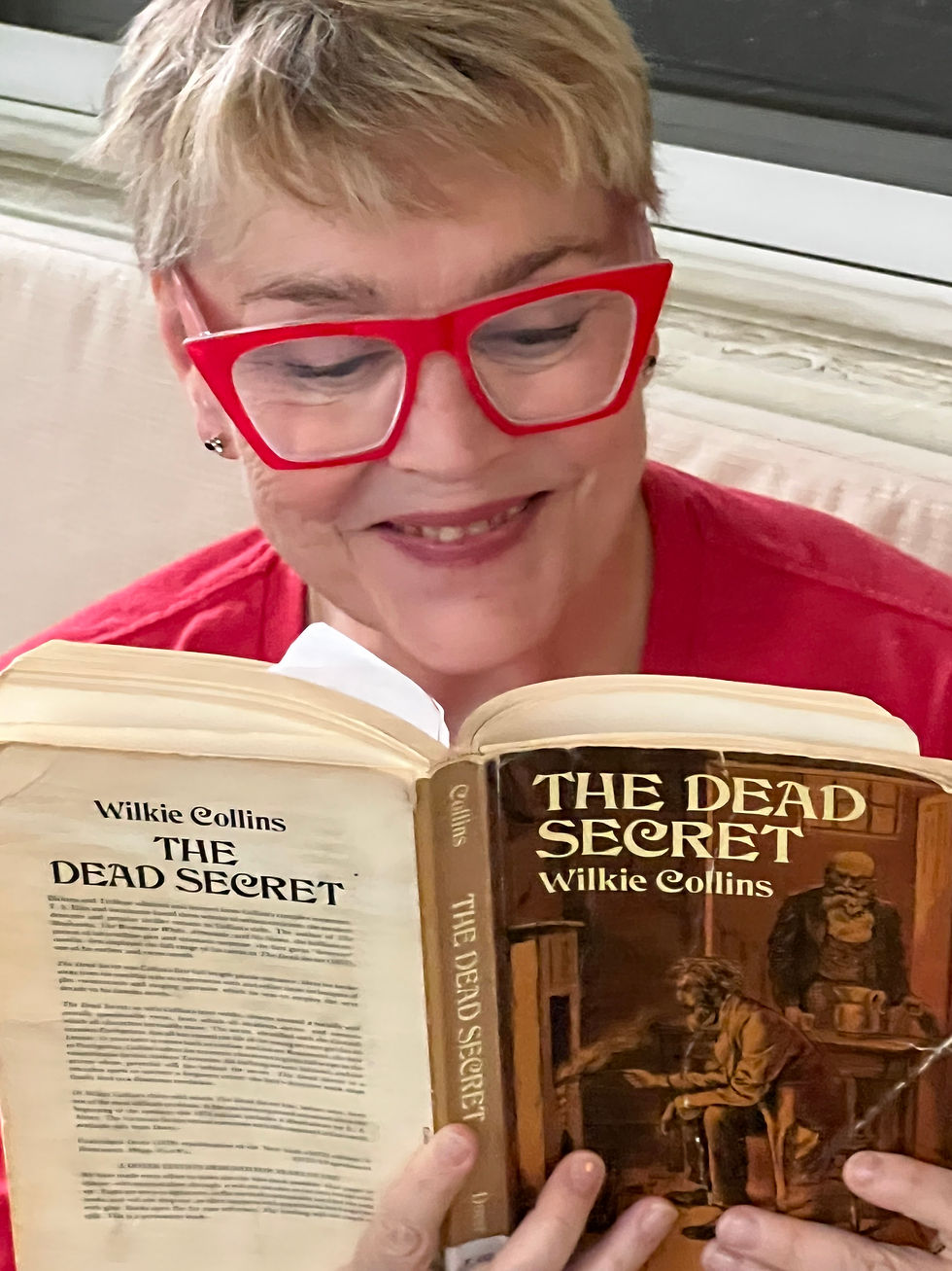 Woman reading a paperback novel.