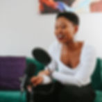 Smiling Working Within CEO Charlyn Moss at podcast microphone