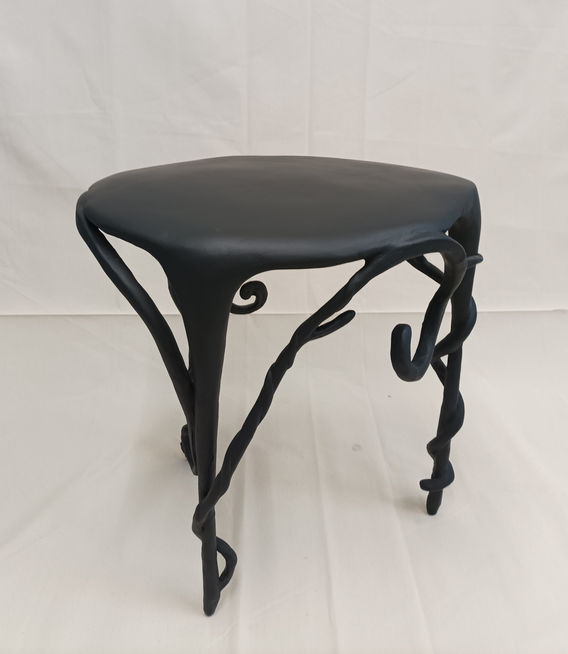  sculptured in organic form 
50 cm x 40 cm x 50 cm (H) side table in dark grey  
functional art , organic form
