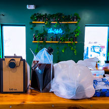 Coffee prepared for a canceled catering event inside a community-focused coffee shop, ready to be donated instead of going to waste.