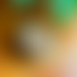 Blue ceramic mug with a latte topped with cinnamon heart art on a wooden table at Eden Cafe.