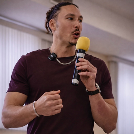 Lawrence Greer speaking to audience during a youth leadership and personal development workshop.