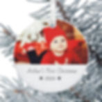 Personalised Christmas tree bauble printed with text Baby's First Christmas and displaying a photo of the baby