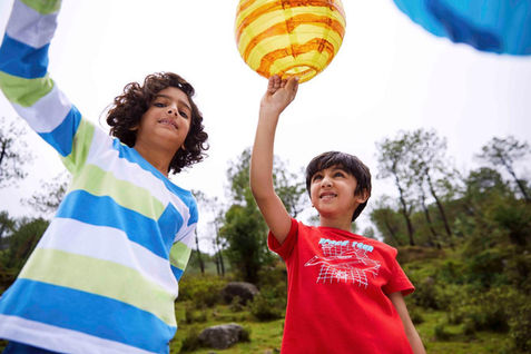 two boys playing with lanterns