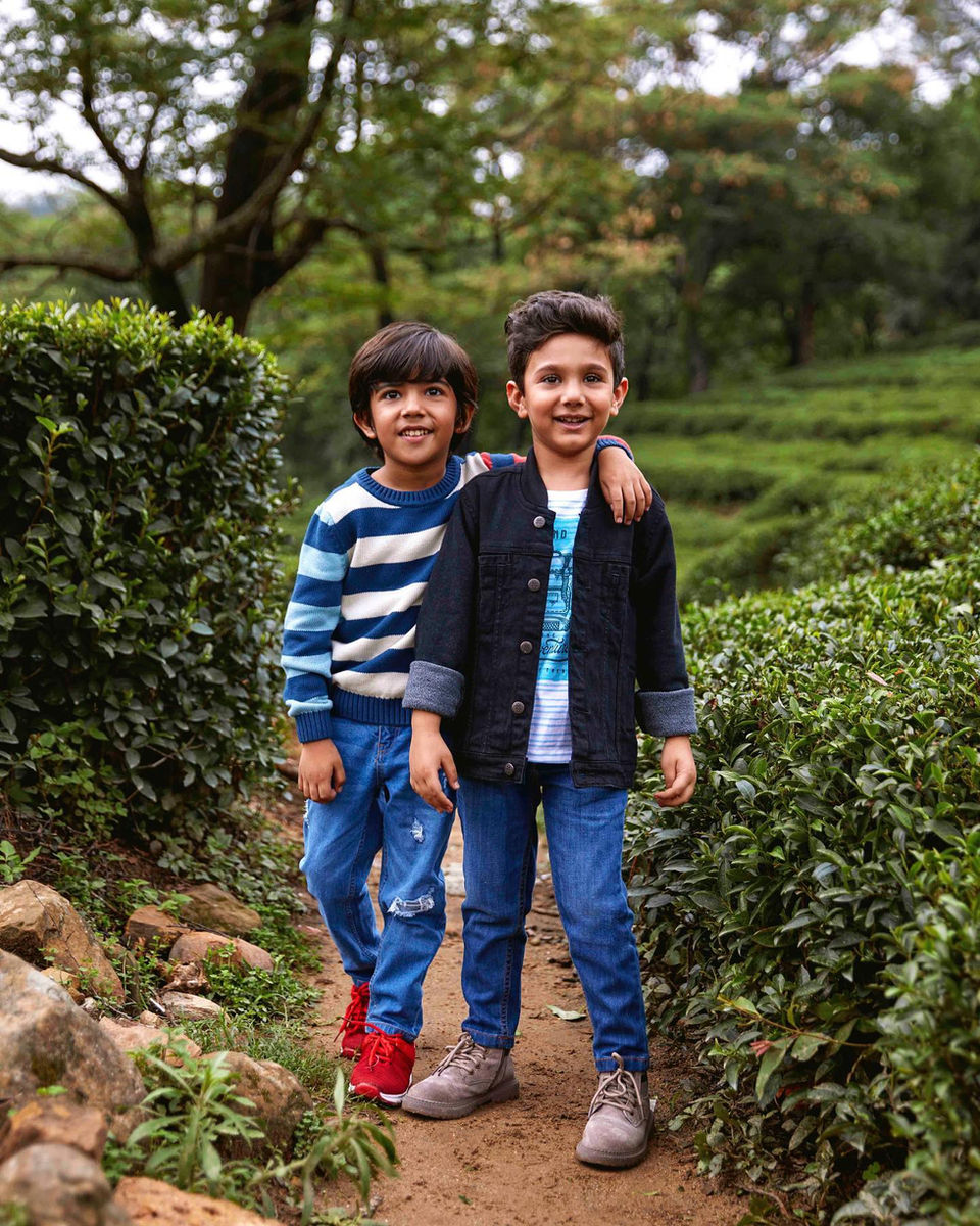 two boys posing for a photo at a tea estate in Dhramshala