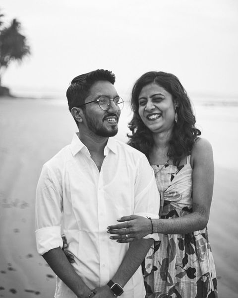 a couple holding each other while sharing a joke