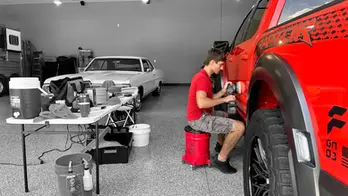 man-buffing-a-red-ford-raptor-in-a-car-garage-kathleen-florida