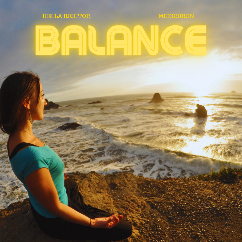 woman sitting in meditation overlooking the ocean sunset