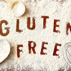 The words "Gluten Free" made in a layer of flour, surrounded by baking tools.