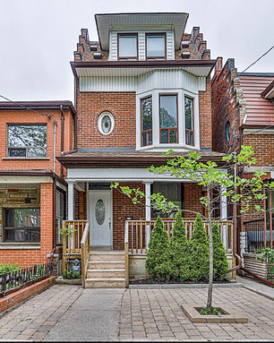 A photo of a 3 storey red brick home in Toronto for lease