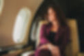 beautiful young woman sits in a plane near the window.jpg