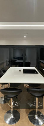 Contemporary kitchen-diner with island, skylight and large garden doors.

