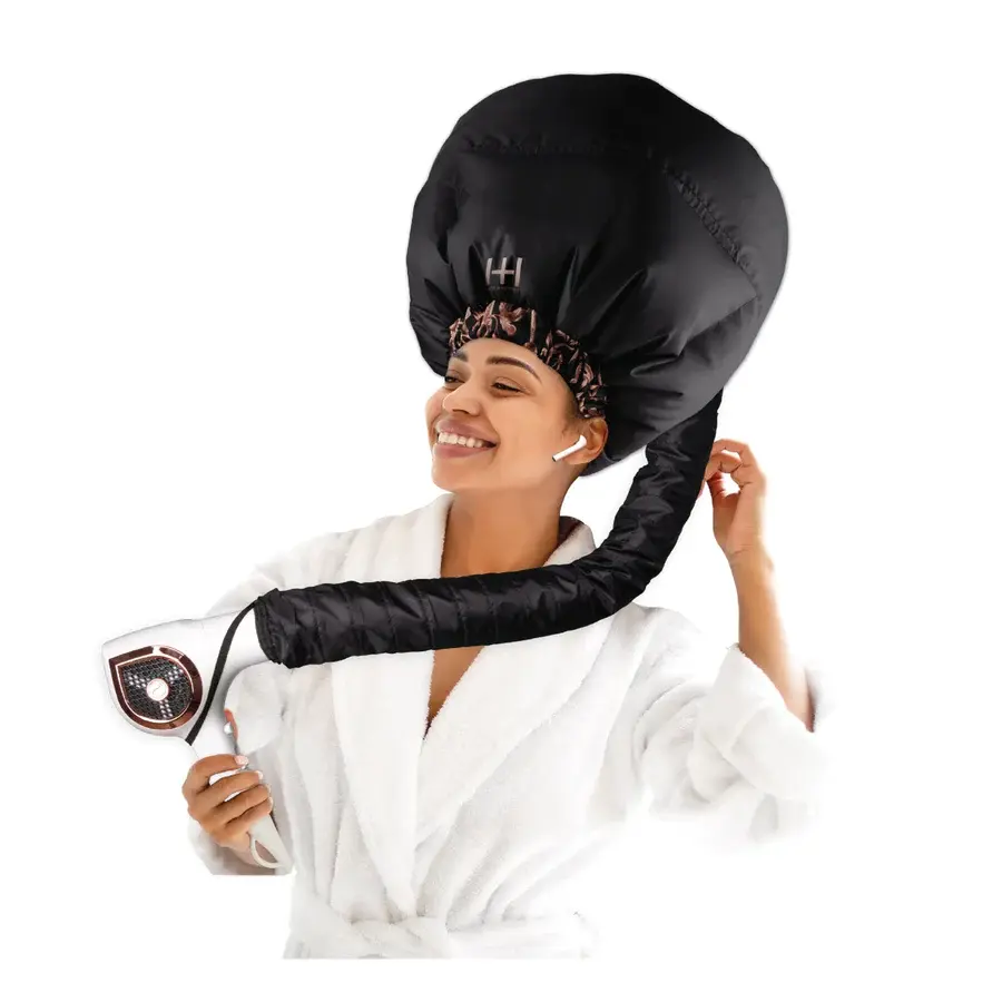 Woman using hair dryer with bonnet. D'Paradise Beauty Supply in white bathrobe.