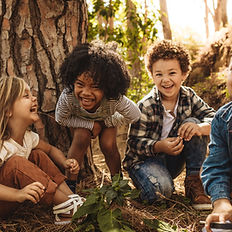 Happy diverse children playing outdoors
