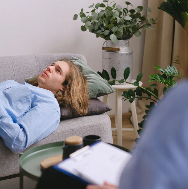Young man lying on couch during therapy session