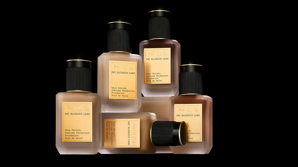 Seis frascos da base "Skin Fetish: Sublime Perfection Foundation" de Pat McGrath Labs organizados de forma artística sobre um fundo preto sólido. Os frascos são de vidro fosco com cantos chanfrados, ostentando rótulos dourados brilhantes e tampas pretas com detalhes em ouro. O conteúdo dos frascos mostra uma variedade de tons, indo do bege claro ao marrom profundo. Cinco frascos estão em pé em diferentes alturas, enquanto um frasco está deitado horizontalmente na base da composição, criando um visual luxuoso e sofisticado.