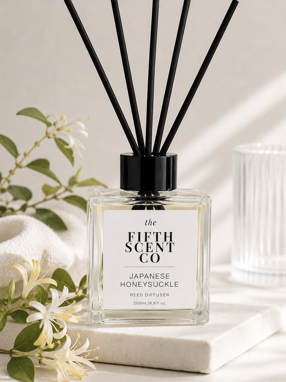 Japanese Honeysuckle Reed Diffuser with black reeds and honeysuckle blooms, showcasing its sweet floral fragrance.