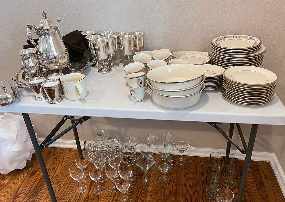 a folding table laden with silver and china