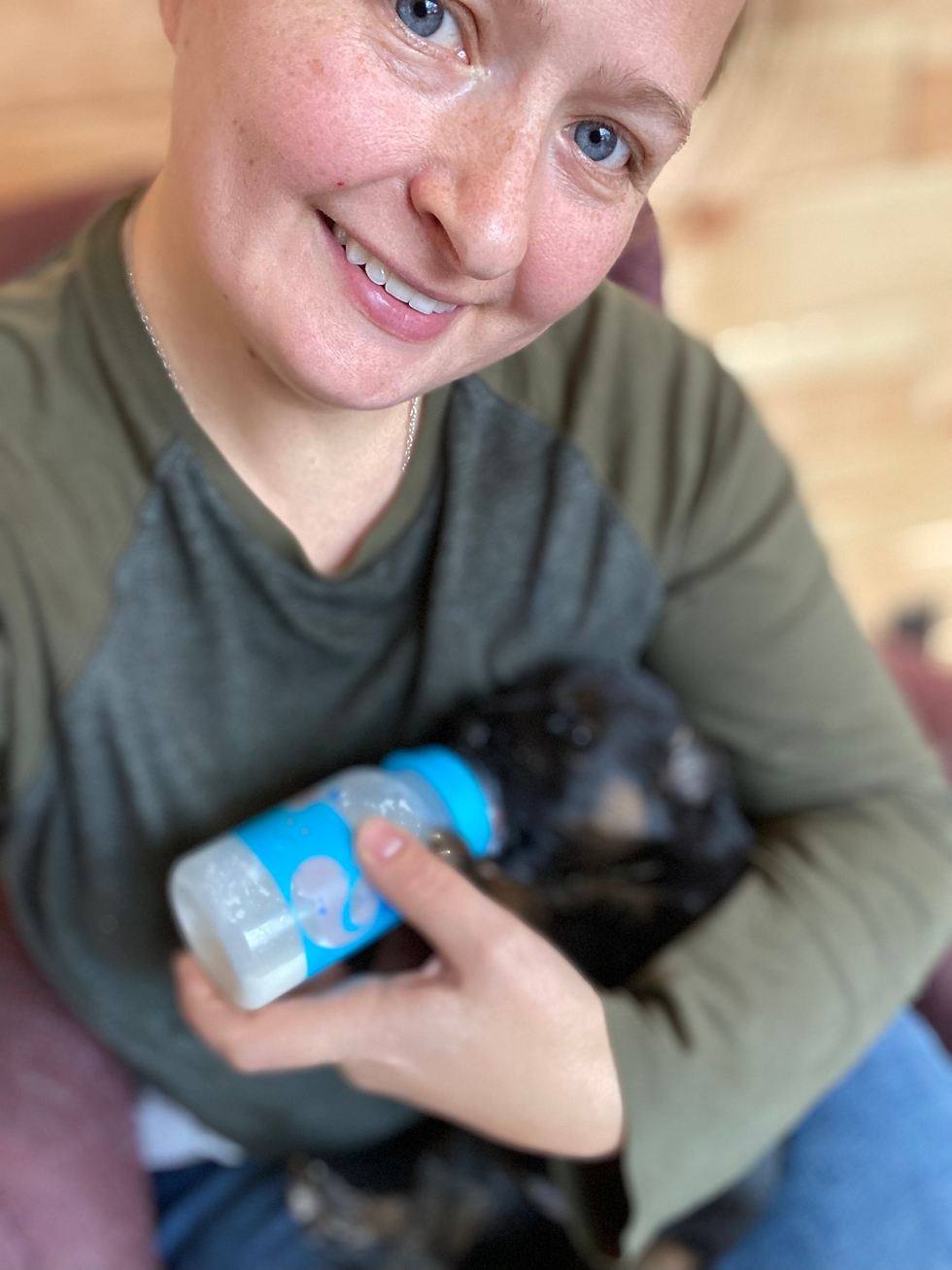 bottle feeding a puppy