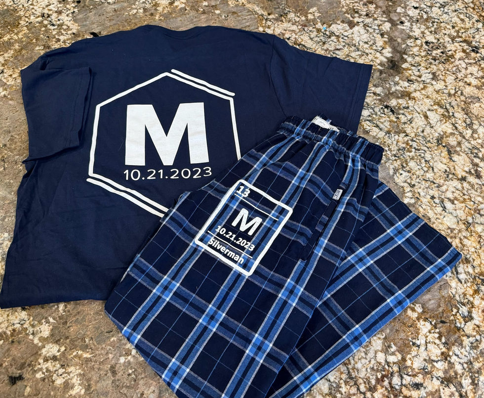 T-Shirts and Flannel Pants with logos on a countertop